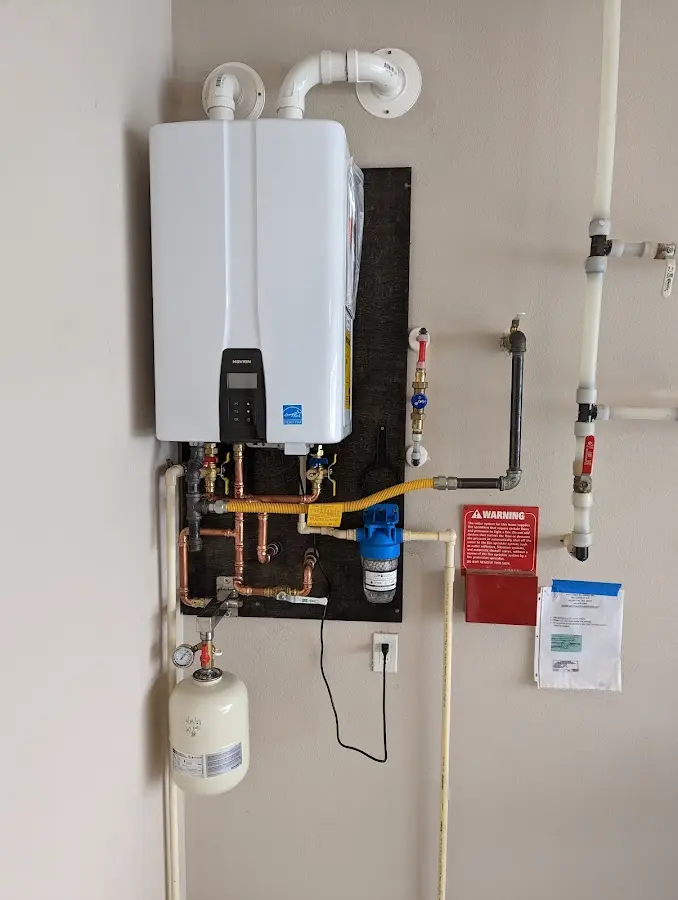 Professional plumber installing copper piping in a South Jordan home